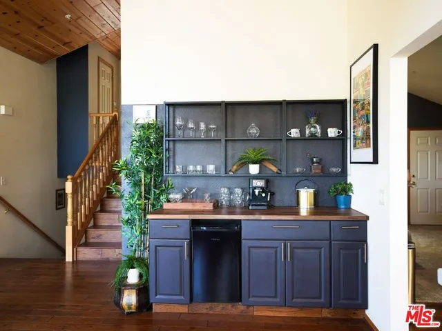 a kitchen with a sink cabinets and wooden floor