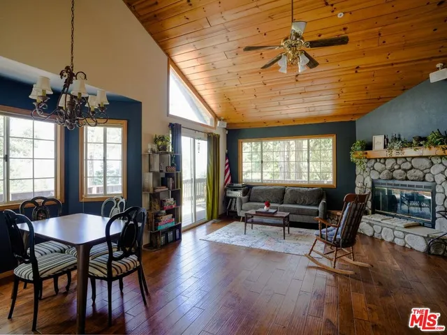 a living room with furniture a window and wooden floor