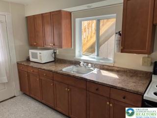 216 Cattell Street, Unit B Easton, PA 18042 - Photo 3 of 14 a bathroom with a granite countertop sink and a window