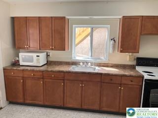 216 Cattell Street, Unit B Easton, PA 18042 - Photo 4 of 14 a kitchen with granite countertop a sink and a stove