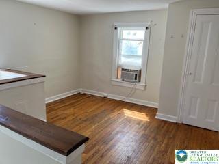 216 Cattell Street, Unit B Easton, PA 18042 - Photo 6 of 14 an empty room with wooden floor and windows
