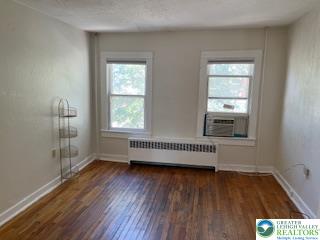 216 Cattell Street, Unit B Easton, PA 18042 - Photo 9 of 14 an empty room with wooden floor and windows