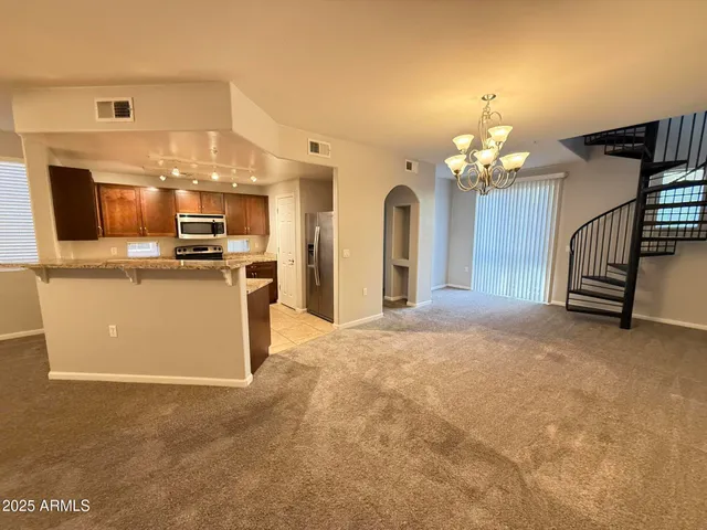 a view of a kitchen with a sink and cabinets