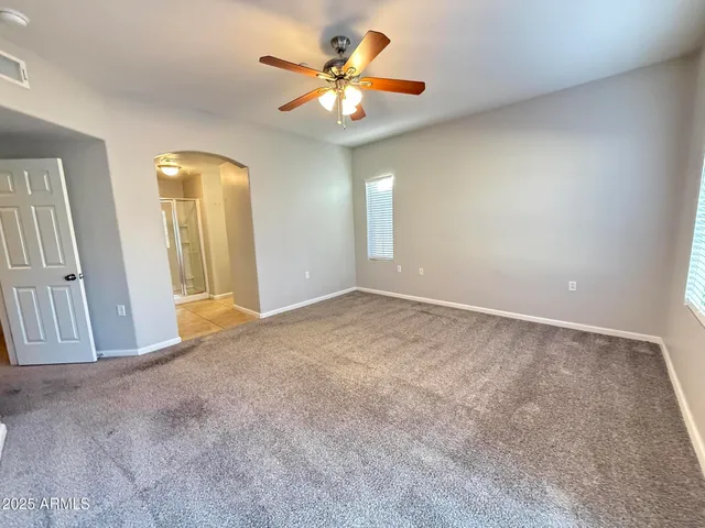 a view of a livingroom with a chandelier fan