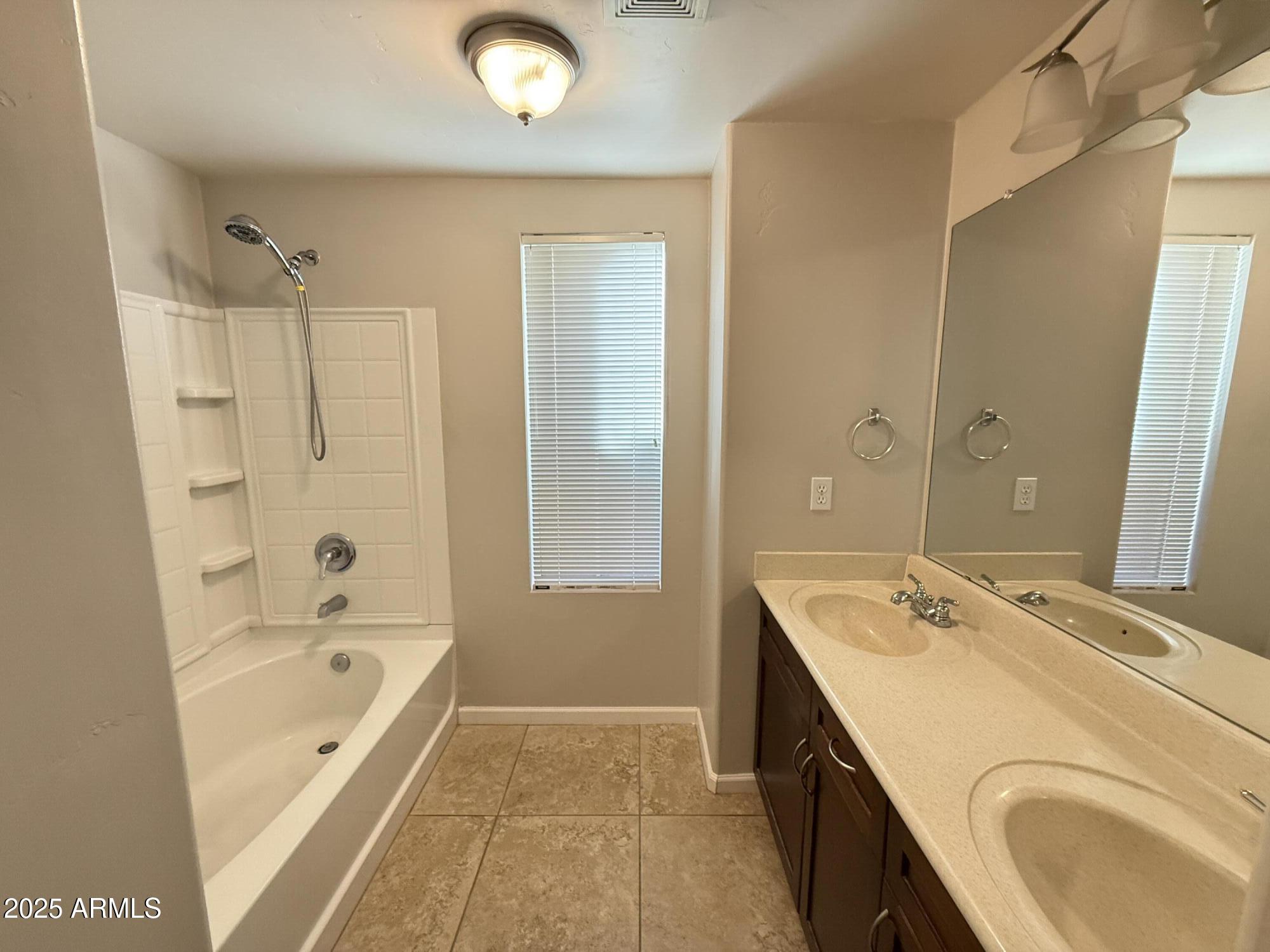 1920 East Bell Road, Unit 1149 Phoenix, AZ 85022 - Photo 28 of 33 a bathroom with a granite countertop tub sink a mirror and a shower