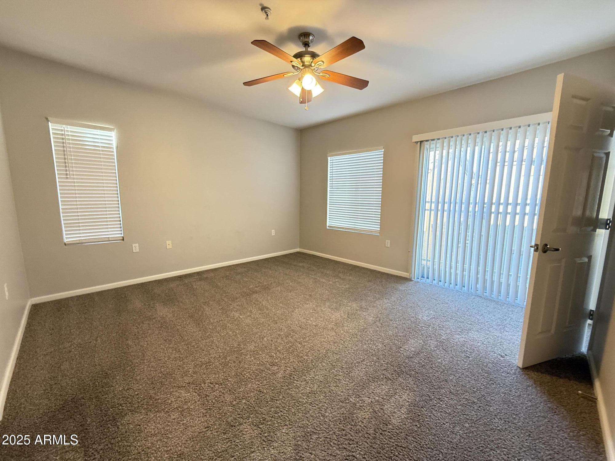 1920 East Bell Road, Unit 1149 Phoenix, AZ 85022 - Photo 29 of 33 a view of a livingroom with a ceiling fan and window
