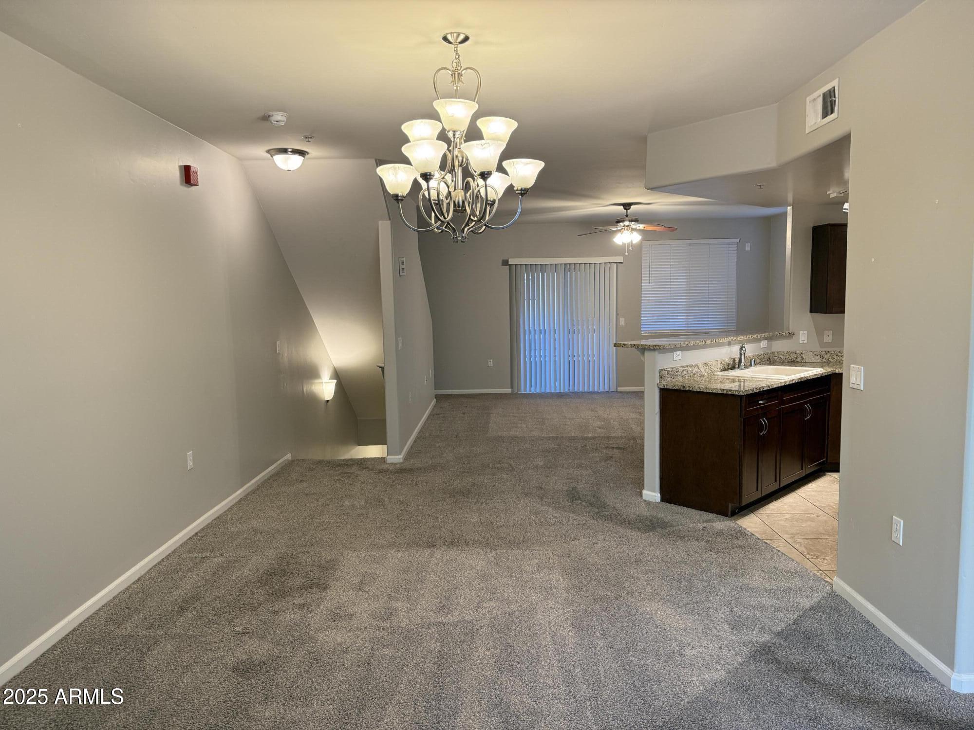 1920 East Bell Road, Unit 1149 Phoenix, AZ 85022 - Photo 30 of 33 a view of a kitchen with a sink and chandelier