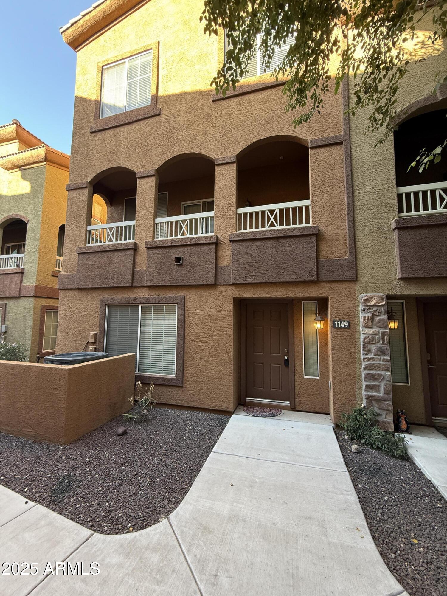 1920 East Bell Road, Unit 1149 Phoenix, AZ 85022 - Photo 3 of 33 a view of a brick building with many windows