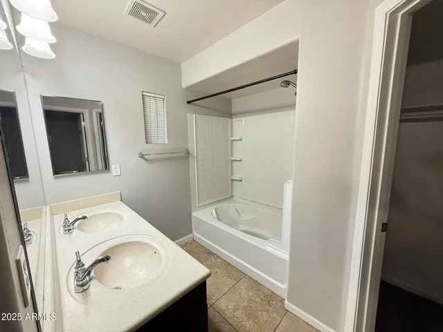 a bathroom with a sink a mirror and a bathtub