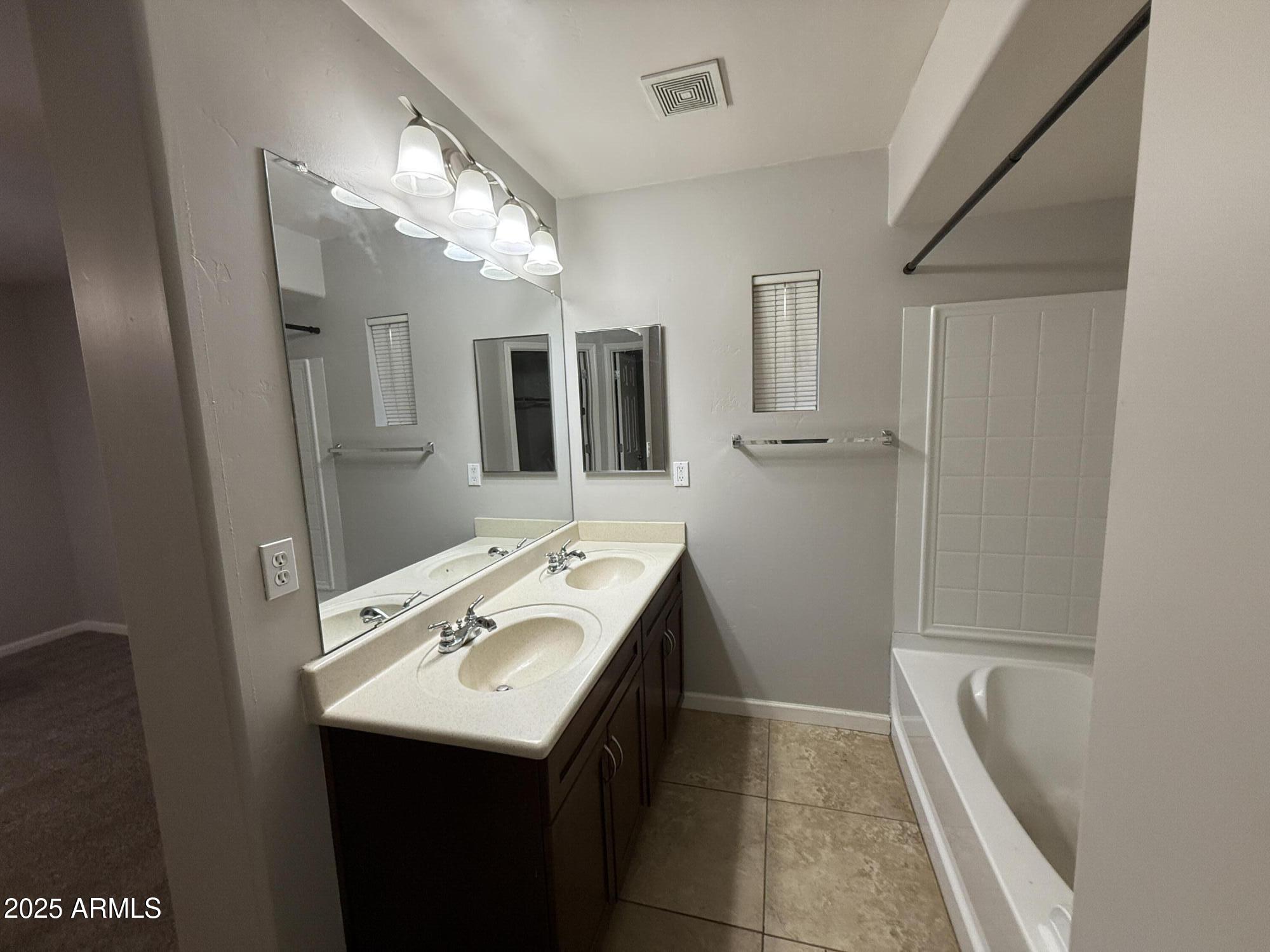 1920 East Bell Road, Unit 1149 Phoenix, AZ 85022 - Photo 7 of 33 a bathroom with a sink a toilet a large mirror and shower