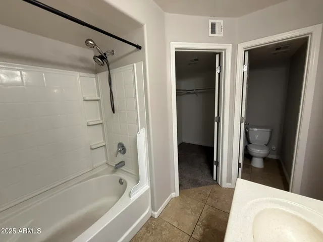 a bathroom with a tub toilet and a sink