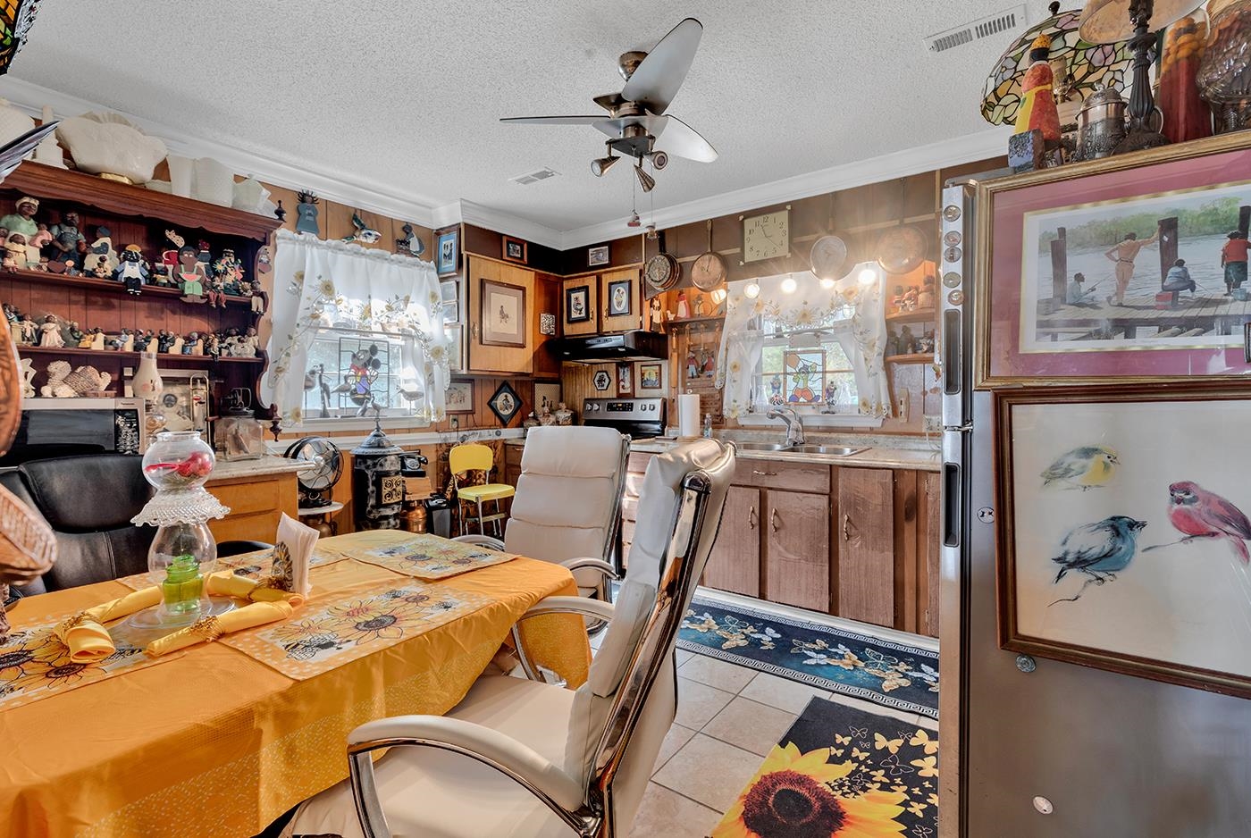 2023 Asbury Street Georgetown, SC 29440 - Photo 11 of 40 Dining room featuring a textured ceiling, light tile patterned flooring, ceiling fan, and crown molding