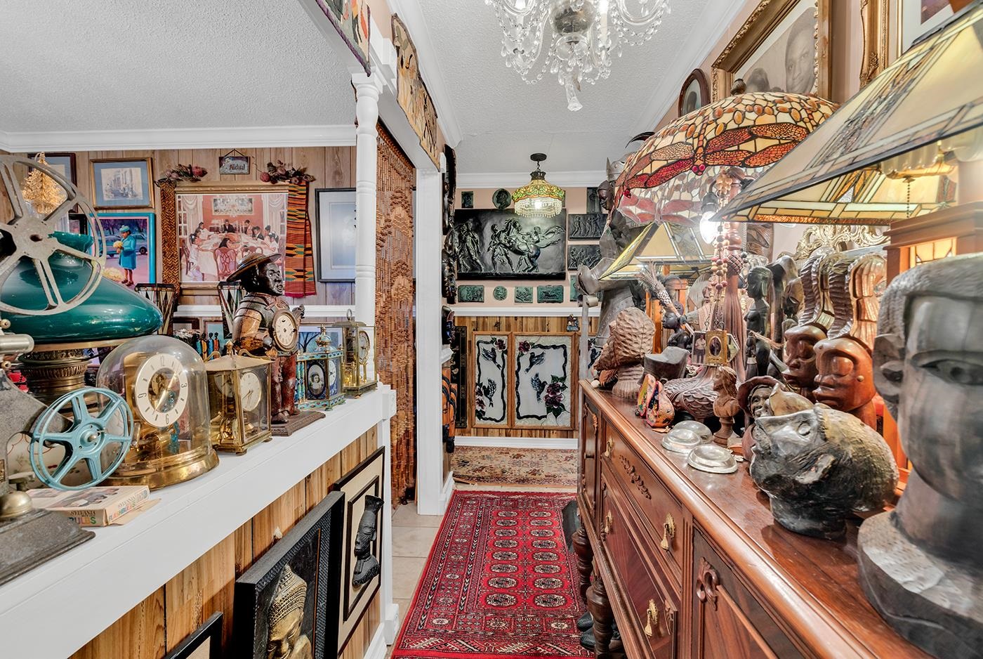 2023 Asbury Street Georgetown, SC 29440 - Photo 15 of 40 Bar area with brown cabinetry, light tile patterned floors, a chandelier, a textured ceiling, and ornamental molding