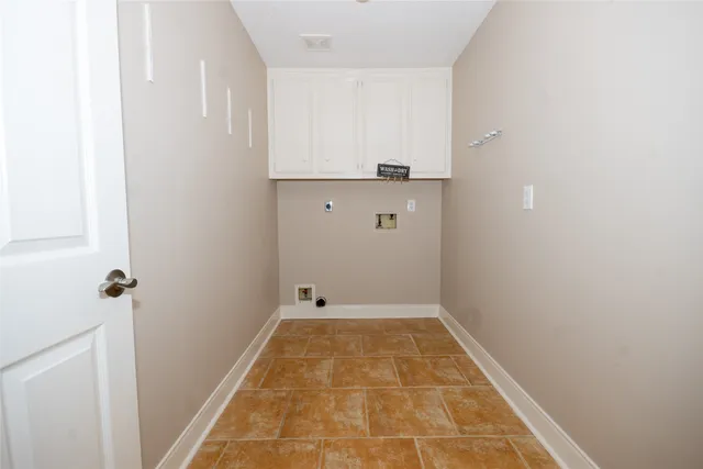 an empty room with chandelier fan