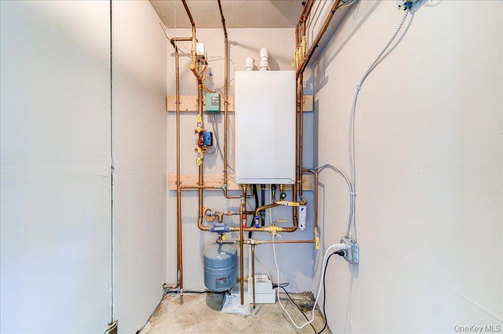 60 Sutton Park Road Poughkeepsie, NY 12603 - Photo 23 of 30 Wall-mounted water heater with copper piping and an expansion tank