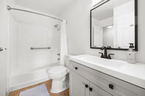 a bathroom with a sink a toilet and a mirror
