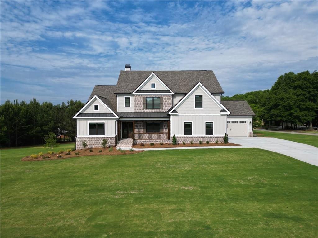 2113 Stonegate Way Monroe, GA 30656 - Photo 2 of 43 a front view of a house with a yard