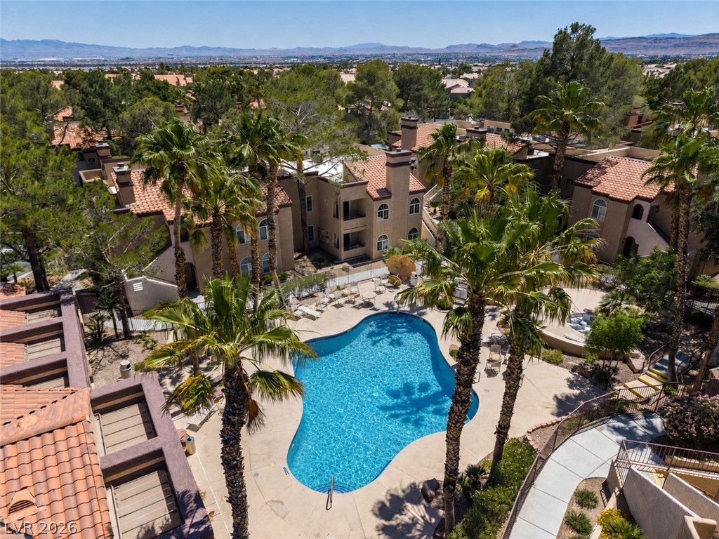 9325 West Desert Inn Road, Unit 244 Las Vegas, NV 89117 - Photo 54 of 55 An aerial perspective reveals a sparkling pool nestled among Mediterranean-style buildings and lush palm trees.