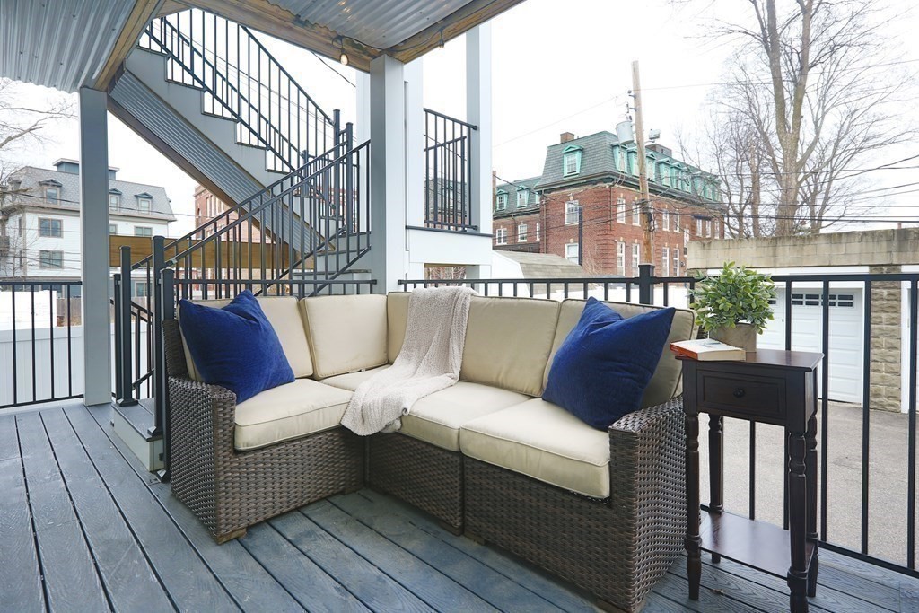 22 Roseclair Street, Unit 1 Boston, MA 02125 - Photo 12 of 14 a roof deck with couches and wooden floor