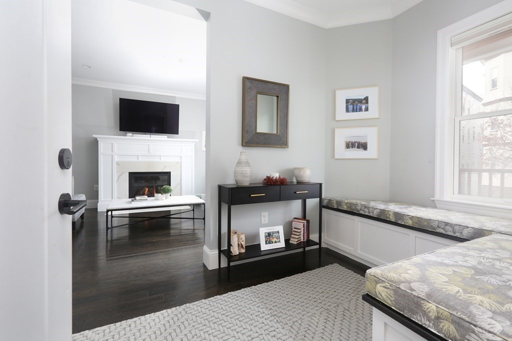 22 Roseclair Street, Unit 1 Boston, MA 02125 - Photo 4 of 14 a living room with furniture and a fireplace