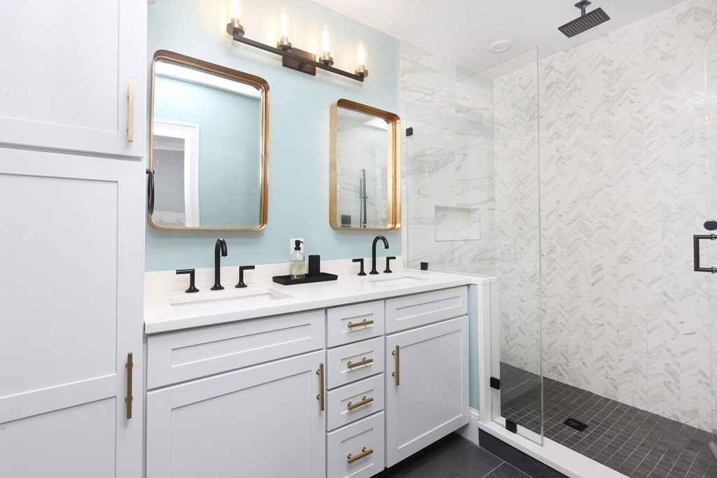 22 Roseclair Street, Unit 1 Boston, MA 02125 - Photo 6 of 14 a bathroom with a double vanity sink a mirror and a