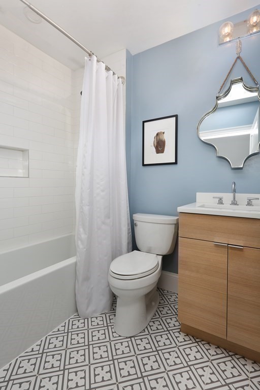 22 Roseclair Street, Unit 1 Boston, MA 02125 - Photo 8 of 14 a bathroom with a toilet a sink and a shower