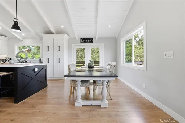 a bathroom with a toilet sink vanity granite and shower