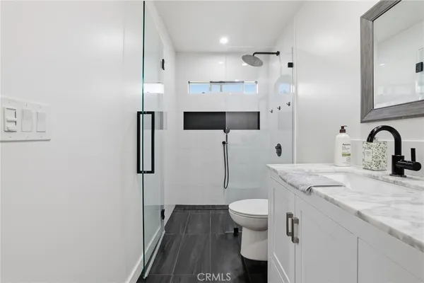 a work room with furniture a flat screen tv and a fireplace