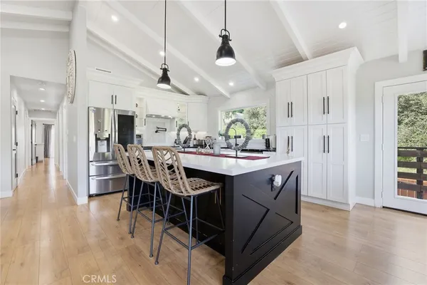 a kitchen with stainless steel appliances a sink stove and refrigerator