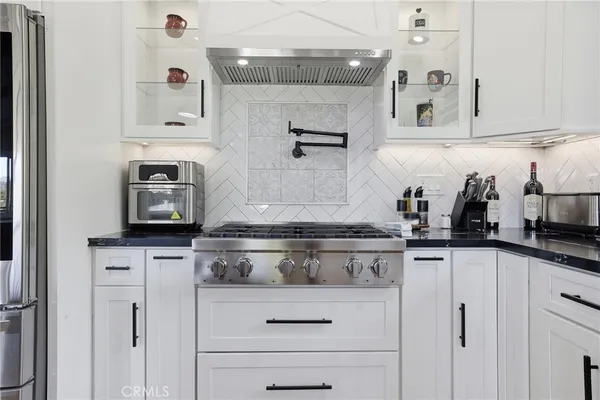 a kitchen with stainless steel appliances granite countertop a refrigerator sink and cabinets