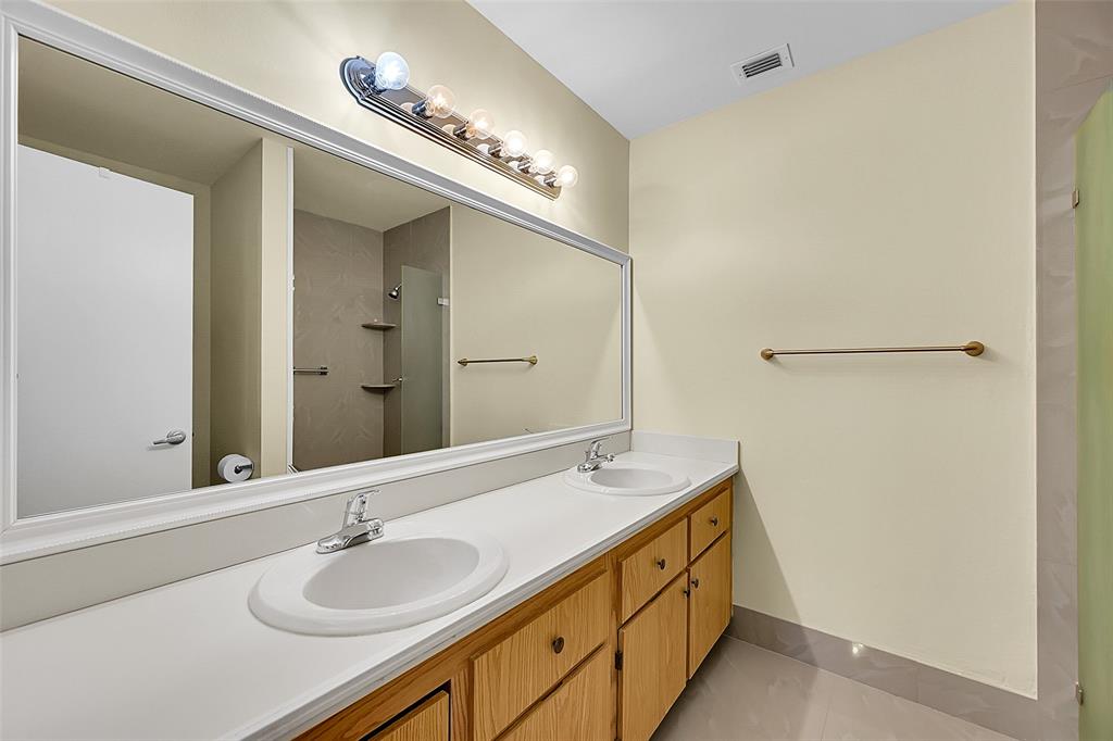 22306 Timberly Drive, Unit 22306 Boca Raton, FL 33428 - Photo 12 of 26 a bathroom with a double vanity sink and a mirror