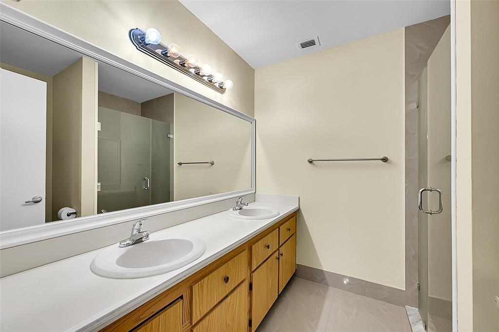 22306 Timberly Drive, Unit 22306 Boca Raton, FL 33428 - Photo 13 of 26 a bathroom with a double vanity sink and a mirror