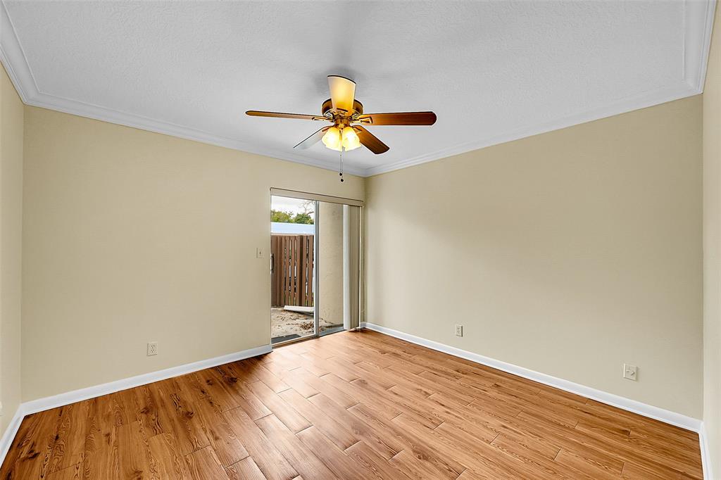 22306 Timberly Drive, Unit 22306 Boca Raton, FL 33428 - Photo 18 of 26 a view of an empty room with window and wooden floor