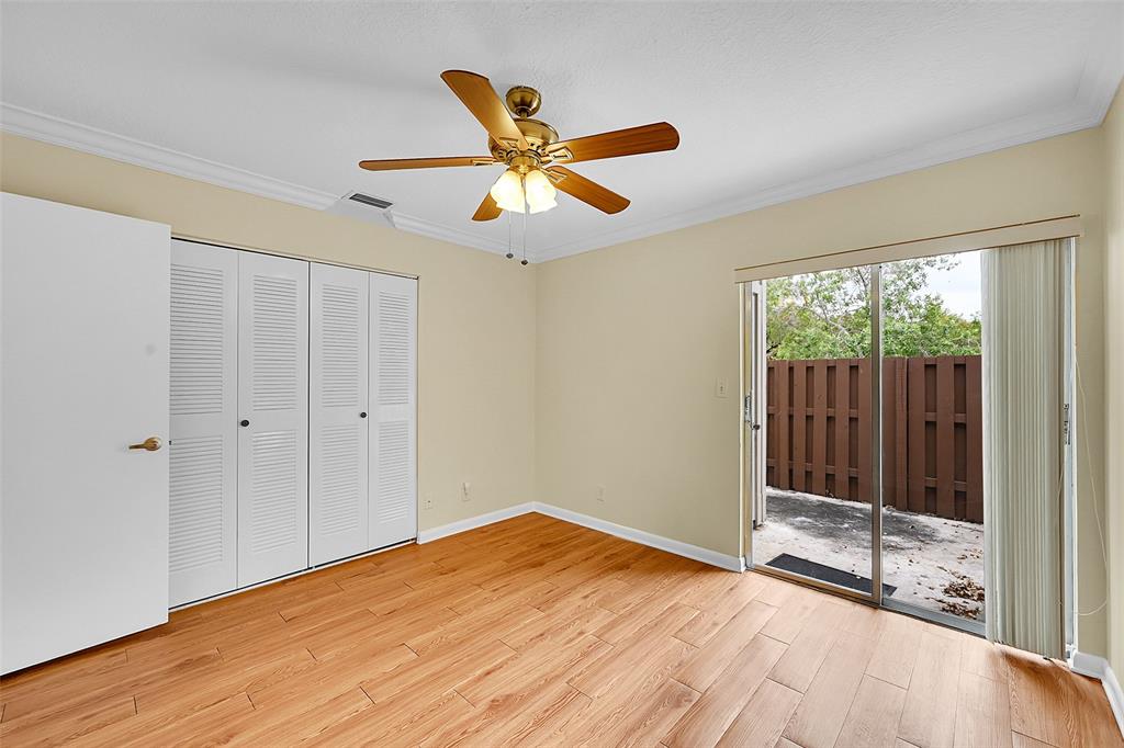 22306 Timberly Drive, Unit 22306 Boca Raton, FL 33428 - Photo 19 of 26 a view of empty room with wooden floor and fan