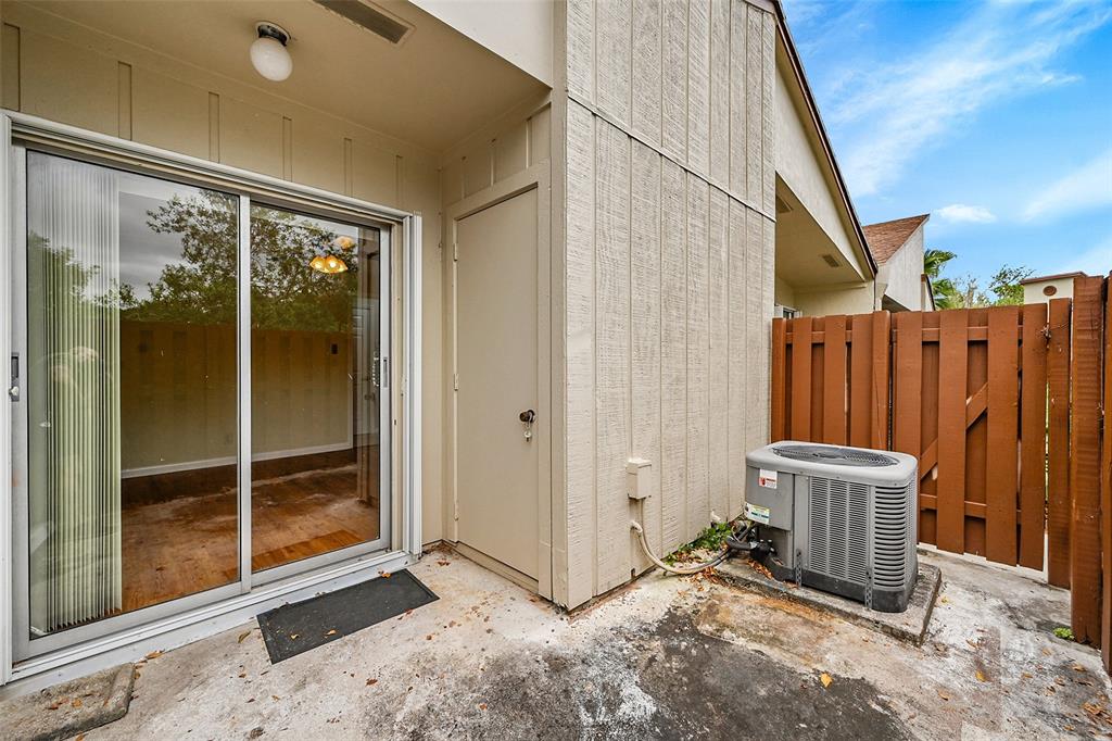 22306 Timberly Drive, Unit 22306 Boca Raton, FL 33428 - Photo 20 of 26 a view of a door with wooden fence