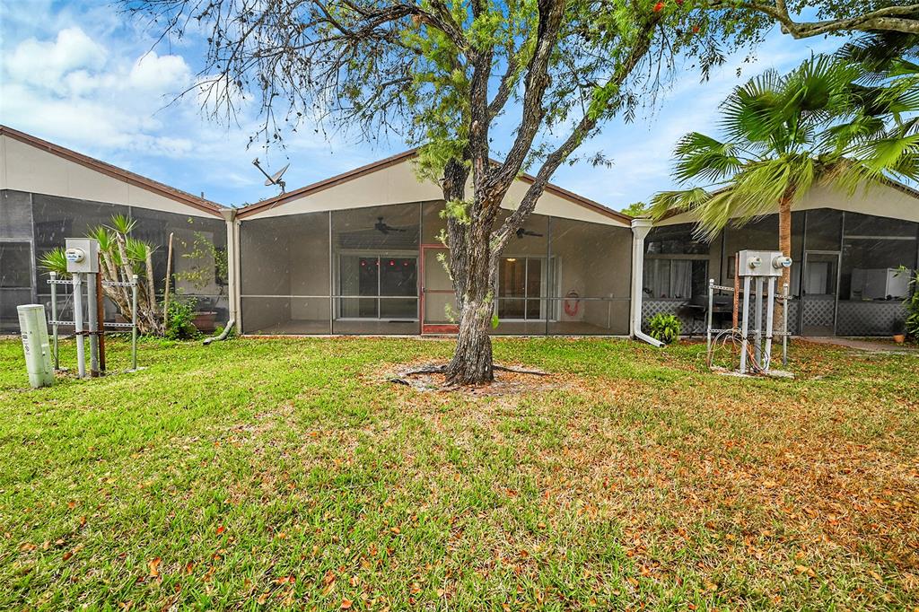 22306 Timberly Drive, Unit 22306 Boca Raton, FL 33428 - Photo 25 of 26 a front view of a house with a yard