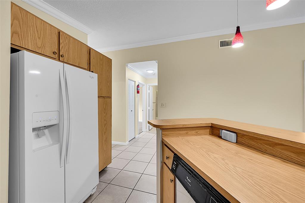 22306 Timberly Drive, Unit 22306 Boca Raton, FL 33428 - Photo 4 of 26 a kitchen with a sink and refrigerator
