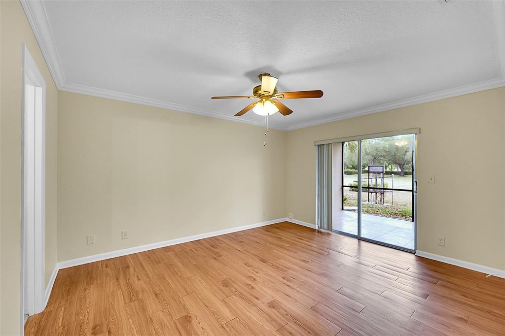 22306 Timberly Drive, Unit 22306 Boca Raton, FL 33428 - Photo 8 of 26 wooden floor in an empty room with a window