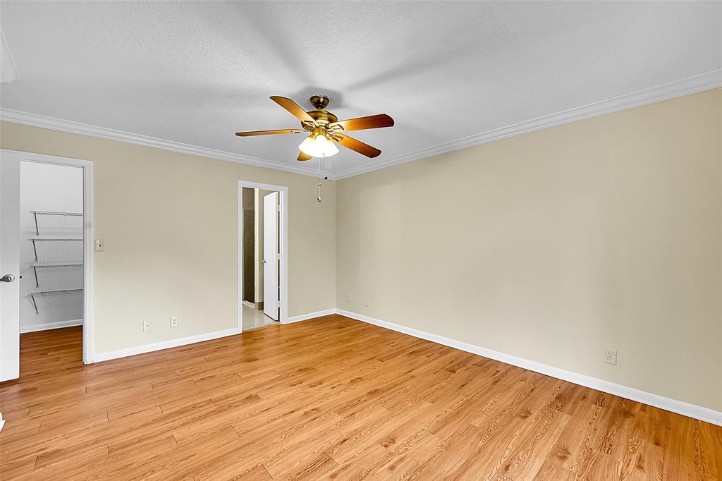22306 Timberly Drive, Unit 22306 Boca Raton, FL 33428 - Photo 9 of 26 a view of an empty room with wooden floor and a window