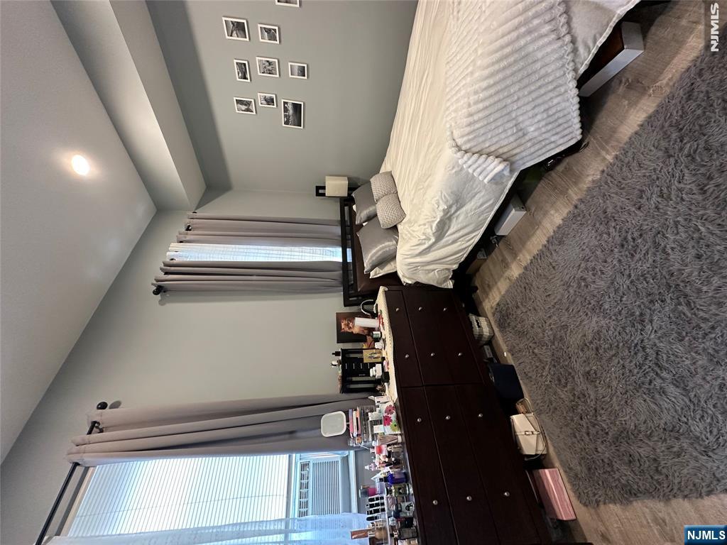 128 Locust Avenue, Unit D Wallington, NJ 07057 - Photo 7 of 8 a bedroom with a bed and a dresser