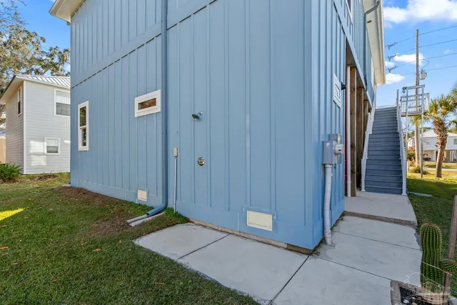 a living room with furniture large window and wooden floor