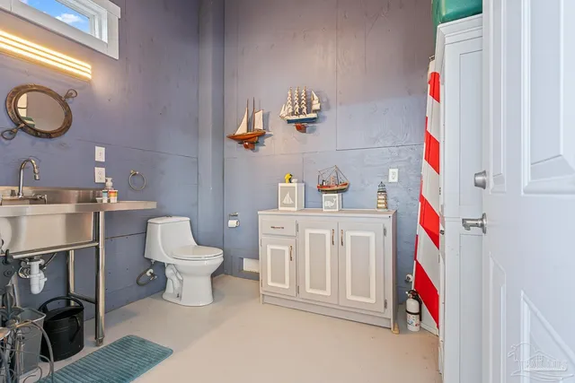 a living room with furniture flat screen tv and a large window