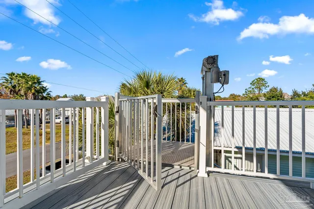 a kitchen with stainless steel appliances a dining table chairs refrigerator and cabinets