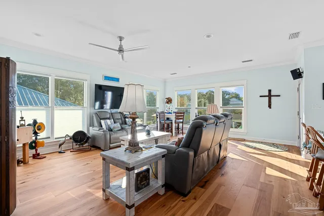 a kitchen with stainless steel appliances granite countertop a sink a stove and a wooden floors