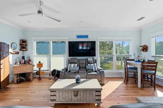 a bedroom with a bed wooden floor and ceiling fan