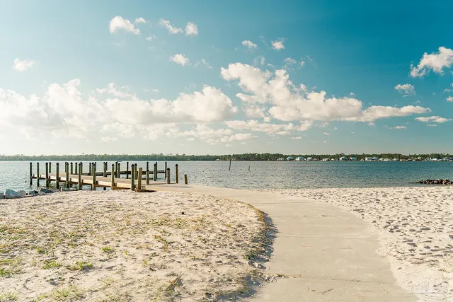 a living room with furniture a rug and a chandelier