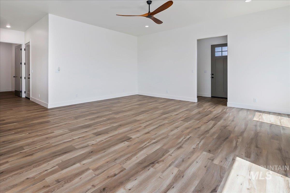 563 Moonstone Road Kimberly, ID 83341 - Photo 5 of 48 Spacious room featuring wood-finish flooring, white walls, recessed lighting, and a modern ceiling fan