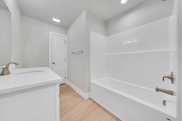 a bathroom with a bathtub and a sink