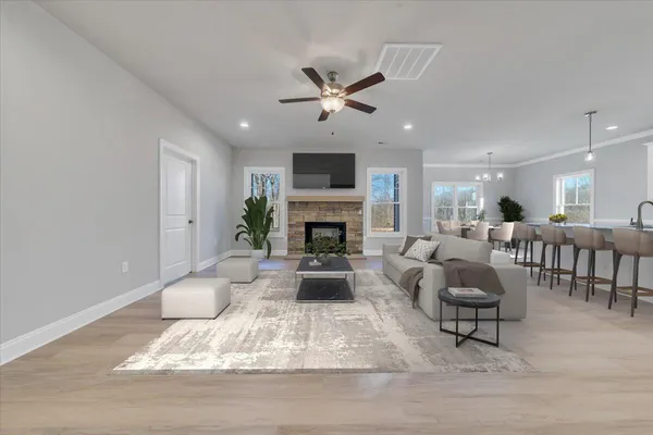 a living room with furniture fireplace and a window