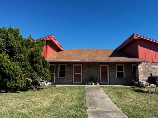 a front view of a house with a garden and porch